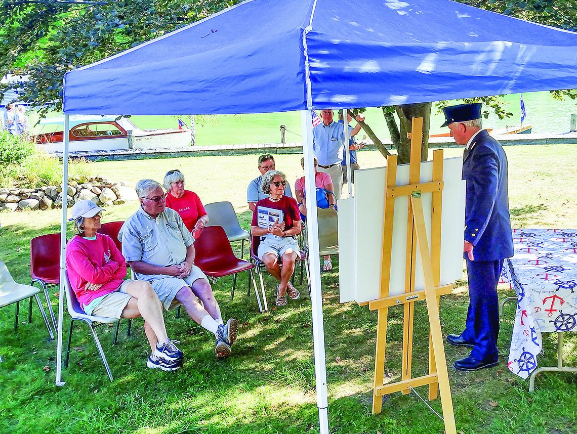 A group gathered under a tent at the Maritime Festival and Wooden Boats on the Wall celebration Saturday in Leland. Enterprise photo by Zachary Marano