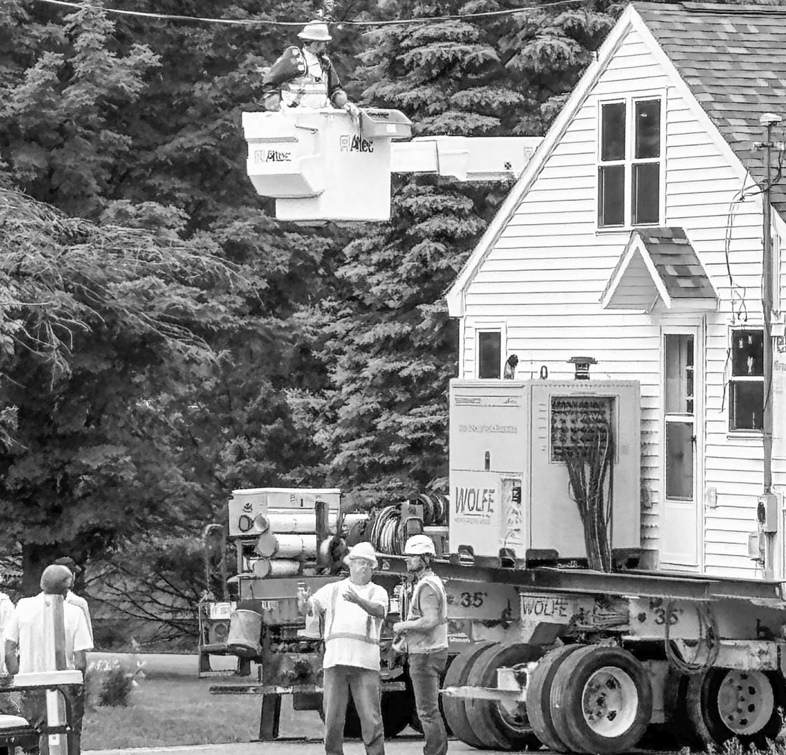 Construction and utility workers coordinated the moving on July 2 of a home owned by the late Theresa Schaub down the street . It is now owned by “Miss Schaub’s” great niece, and remains on the original Jacob Schaub homestead property located south of Lake Leelanau. Photo courtesy of Deb C...