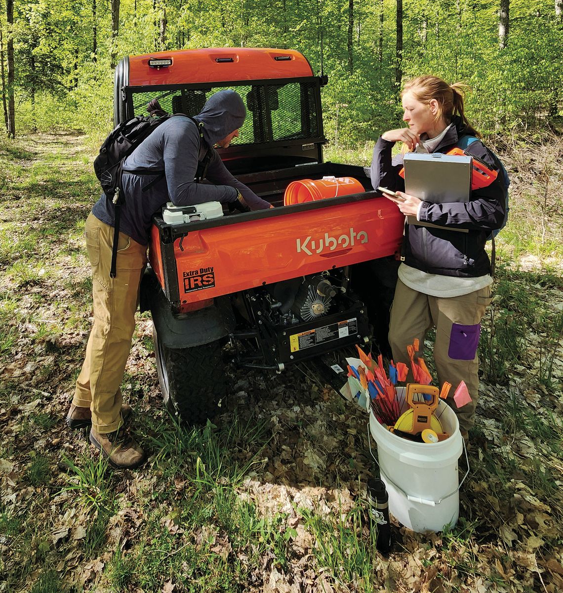 Conservancy land stewards Chad Jordan, left, and Emily Douglas prepare for a day in the field collecting data within deer enclosures at Palmer Woods Forest Preserve. Courtesy photo