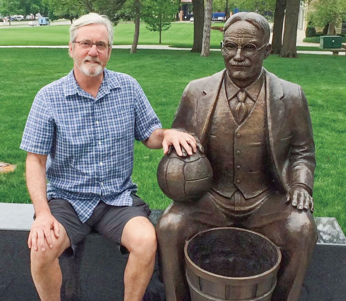 Muldowney sits with a James Naismith statue in Lawrence, Kansas to celebrate his love for basketball. Courtesy photo