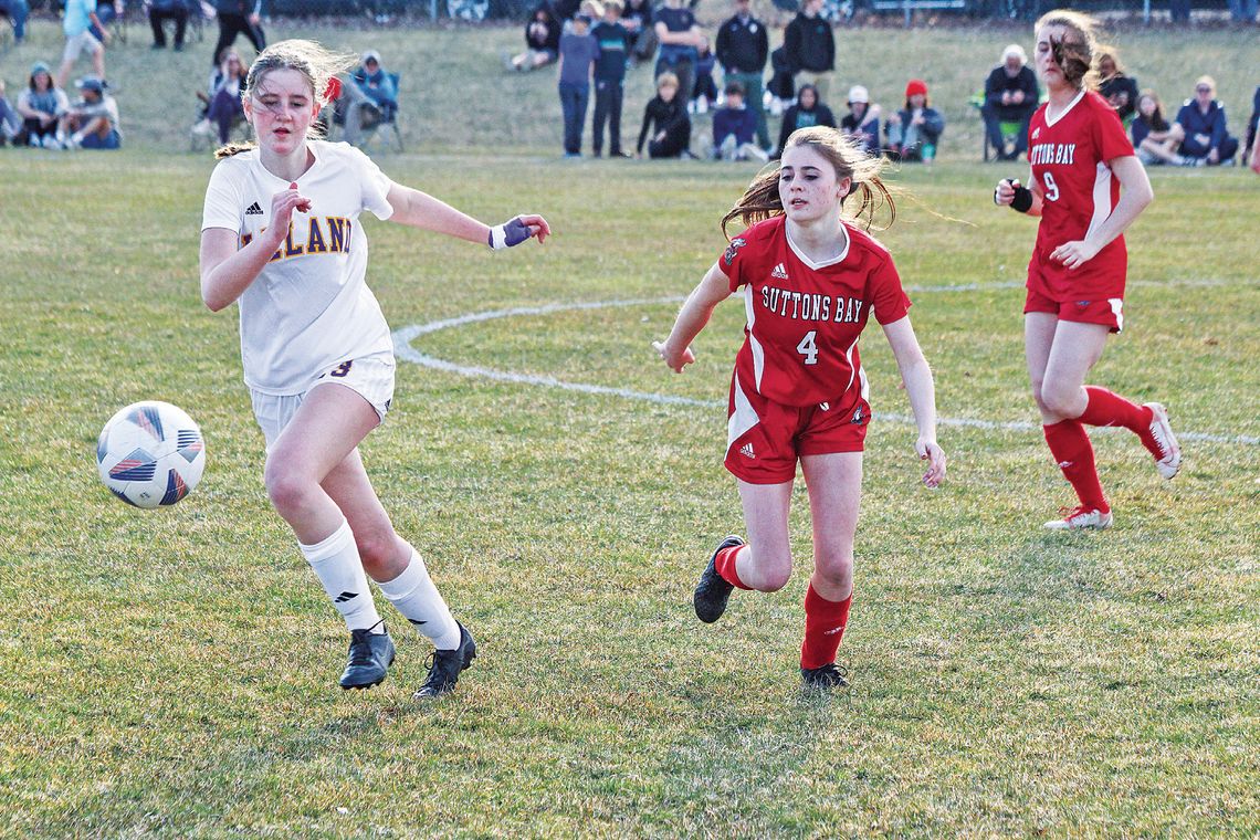 Leland senior Olive Ryder and Suttons Bay senior Lauren Lint compete during the 2023 season. Enterprise photo by Brian Freiberger