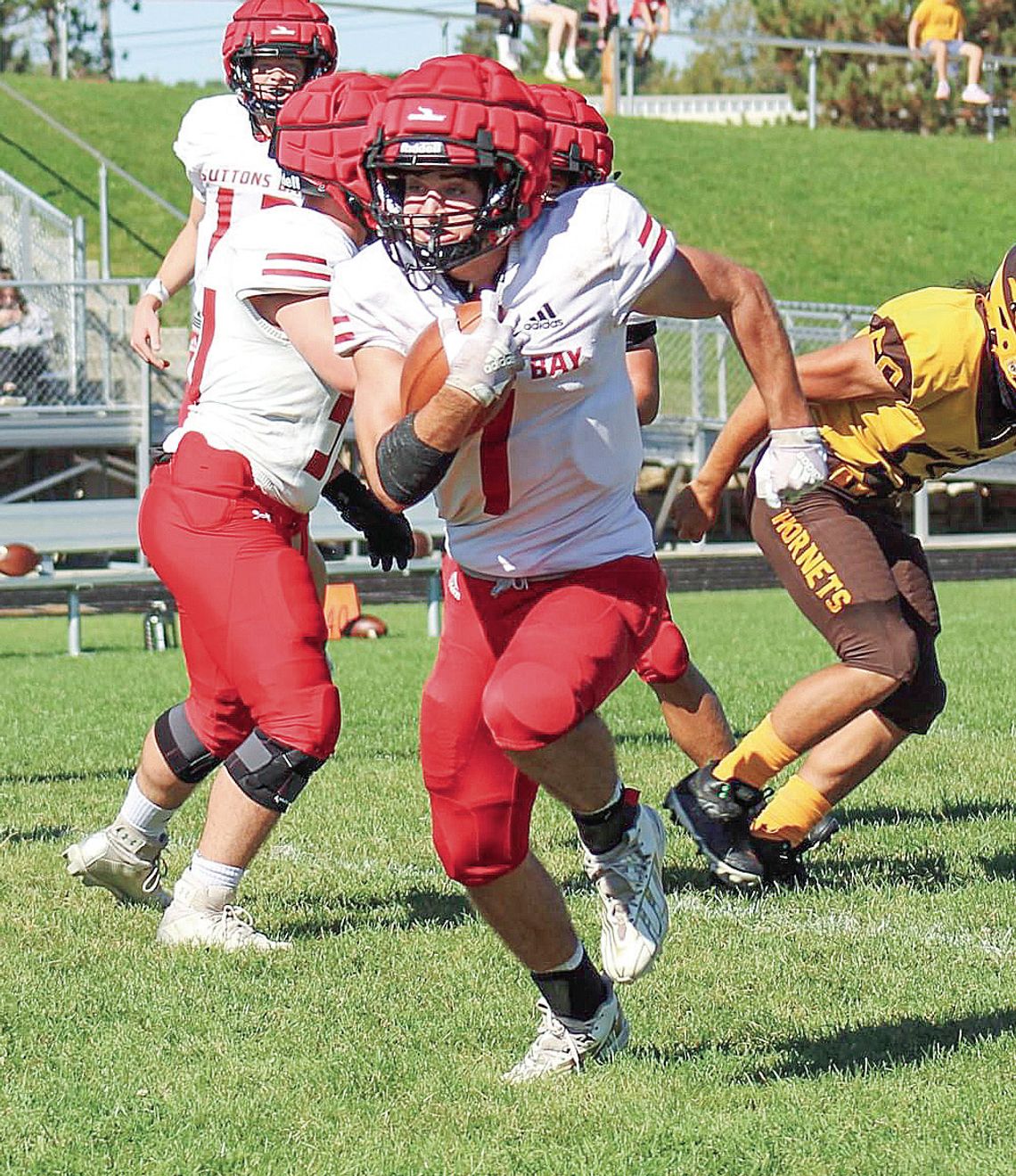 Lake Leelanau St. Mary senior Luke Bramer jukes a defender then races forward for positive yards against Pellston during a 42-16 win Saturday.