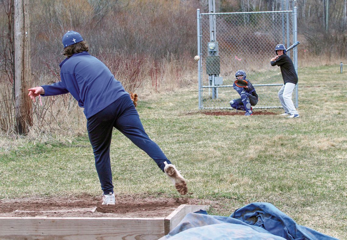 Suttons Bay’s Anthony Oskaboose batting (right) and catcher Gavin Schichtel (left) practice during spring ball Monday. Enterprise photo by Brian Freiberger