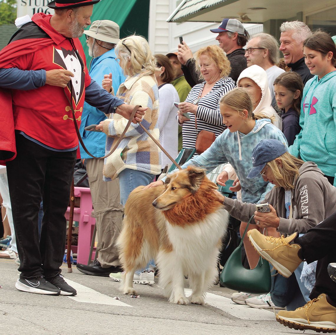 Thousands of people line the street of Northport to get a chance to pet dogs that were participating during the dog parade. Enterprise photo by Brian Freiberger