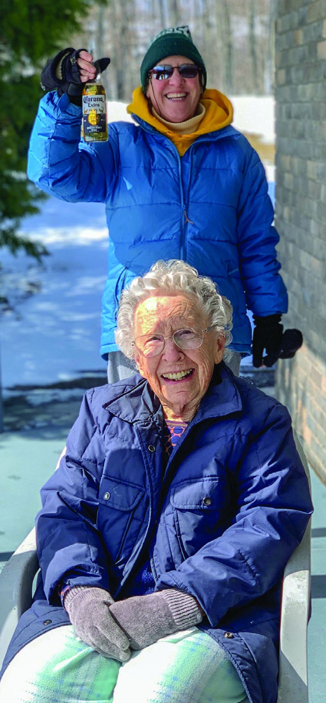 Sue Anderson of Omena maintains ‘social distance’ while checking in on her aunt, Annette Deibel at the onset of the COVID pandemic. Photo courtesy of Sue Anderson