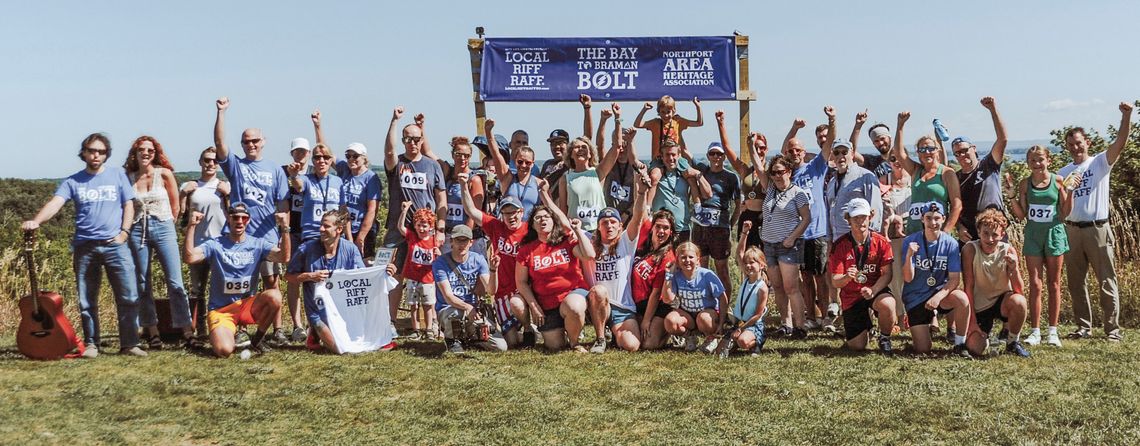 Nearly all “Bolters” of The Bolt 5 in Northport pose for a group photo at the end of the race on Saturday. Courtesy photos