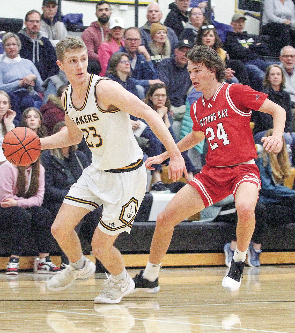 Suttons Bay senior Finn Mankowski (right) guards Glen Lake senior Dylan Cundiff during a district semifinal game Wednesday, February 28.
