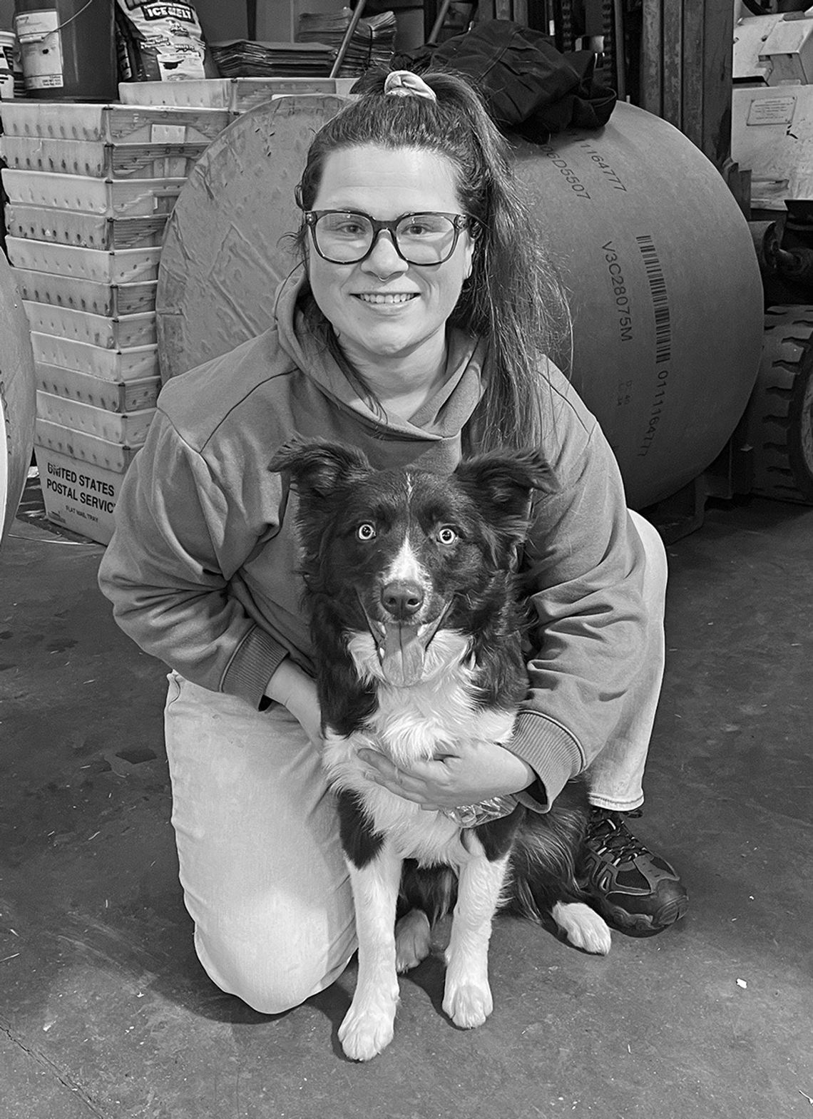 Emily Lingaur is pictured in the Leelanau Enterprise press room with “Chilli,” her family’s 7-month-old border collie. Lingaur grew up visiting the press room as both her parents, Jeff and Sheila, have been working at the Enterprise for more than 20 years now. Enterprise photo by Meakalia...