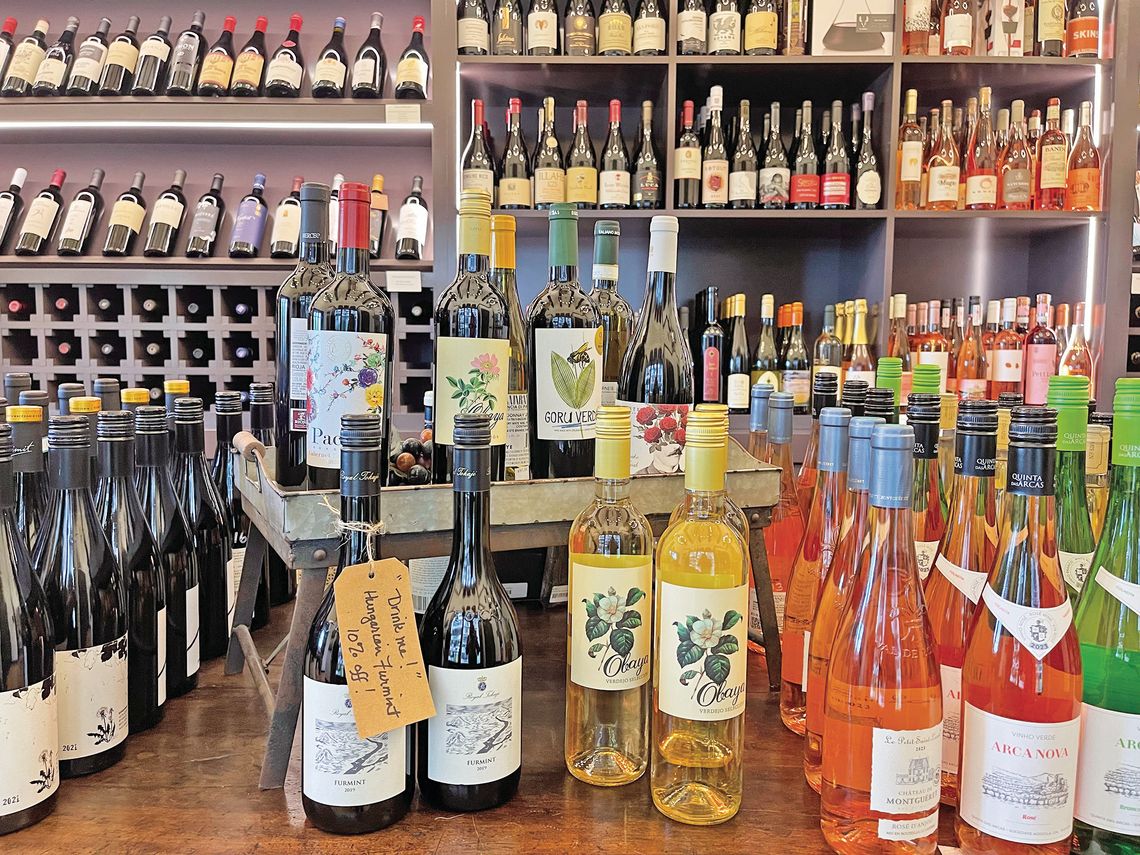 While wine and other alcohol beverage prices range anywhere from $12 to several hundred dollars at Peninsula Provisions, people can find assorted drinks for about $20 and under placed on the lengthy table in the back room of the store.