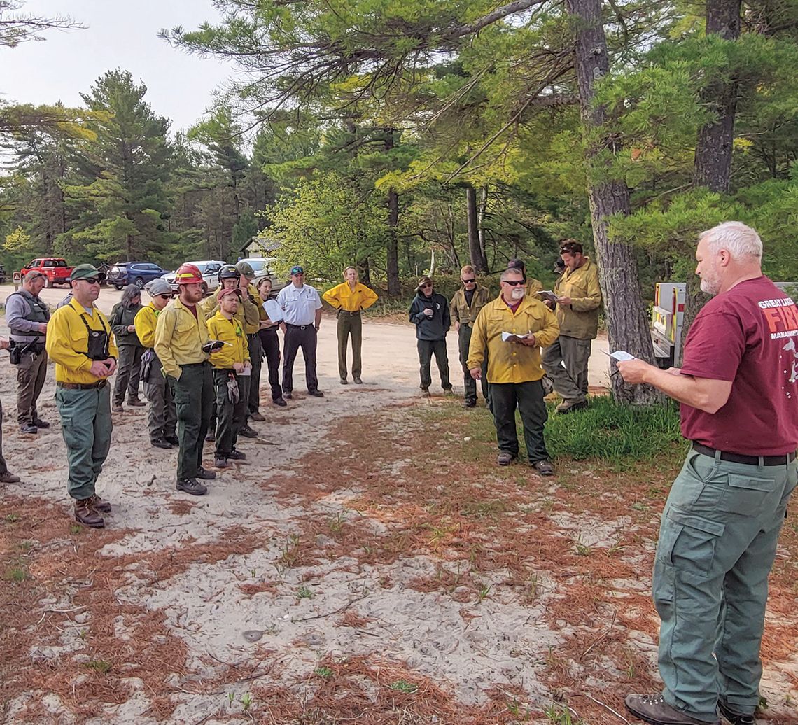 Wildland firefighters meet for a briefing during the 2023 Good Harbor Bay prescribed fire. Photo courtesy of the National Park Service.