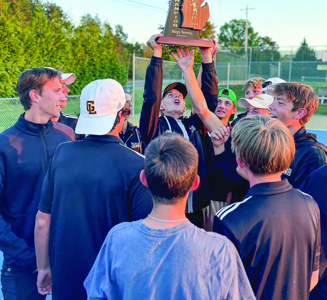 Glen Lake senior Ben Selby hoist the regional championship trophy after the Lakers came from behind to defeat TC St. Francis. The Lakers head to Midland for the state finals meet Monday and Tuesday. Courtesy photo