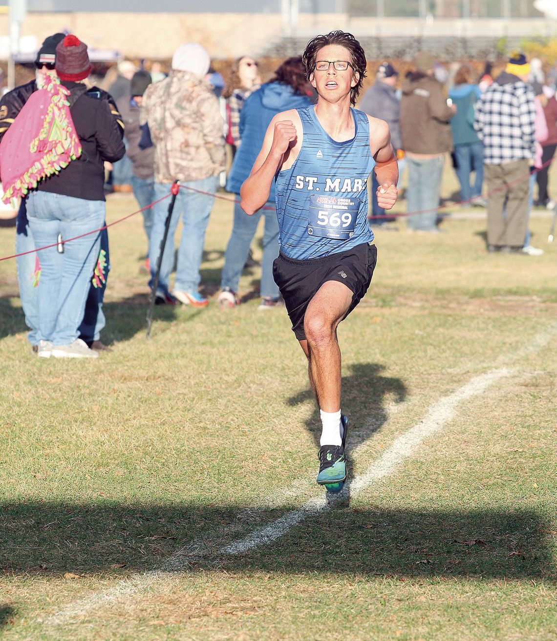 Lake Leelanau St. Mary junior Oliver Mitchell sprints to the finish line at regionals Saturday. Enterprise photo by Brian Freiberger