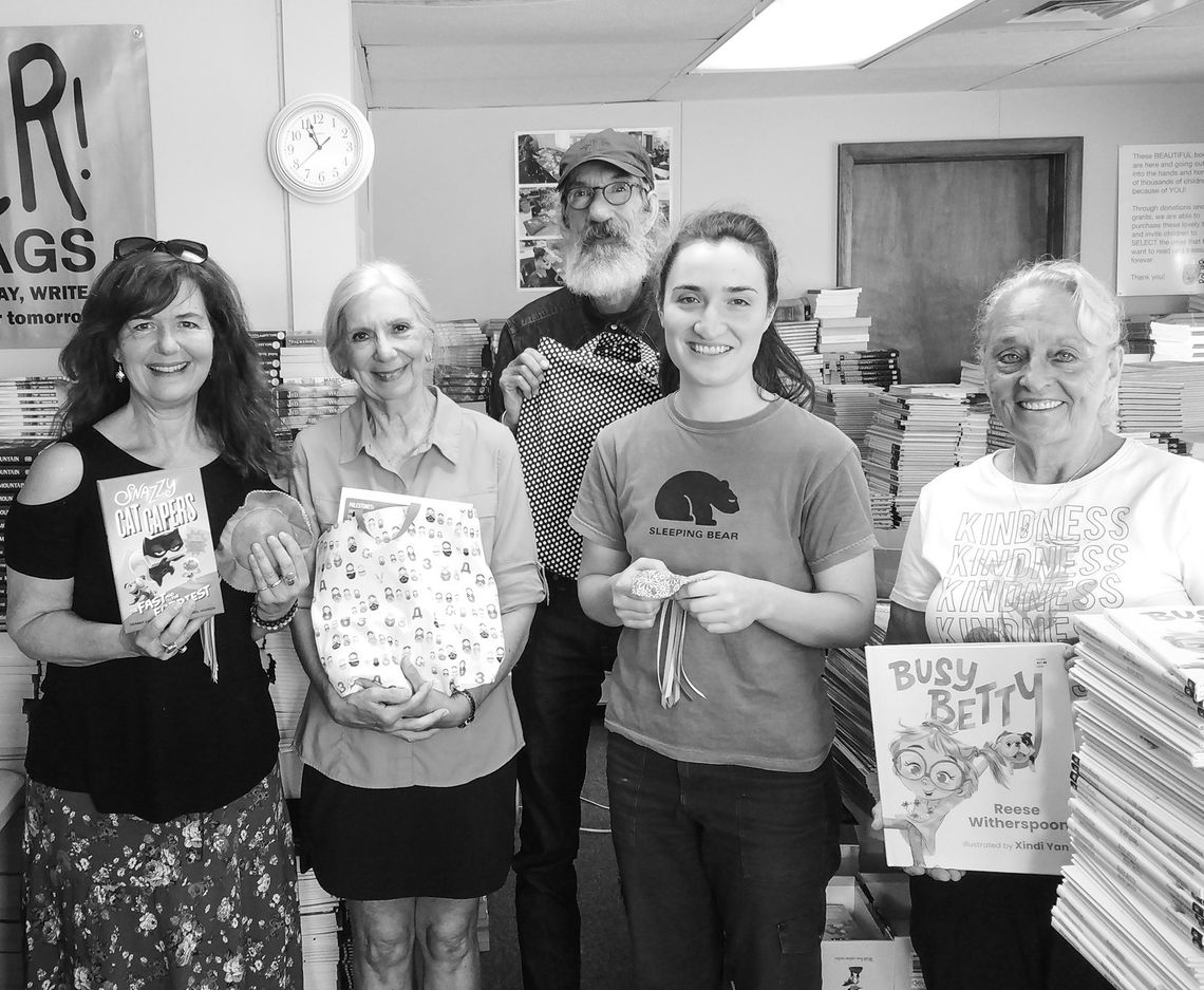 Kara Gregory stands on the far left inside the PoWeR! Book Bags office in Suttons Bay alongside volunteers and the organization’s one employee, Gabrielle David, second from right. The three volunteers, from left, are Lucy Crandell, Guy Plamondon, and Gloria Dean. Enterprise photo by Zachar...