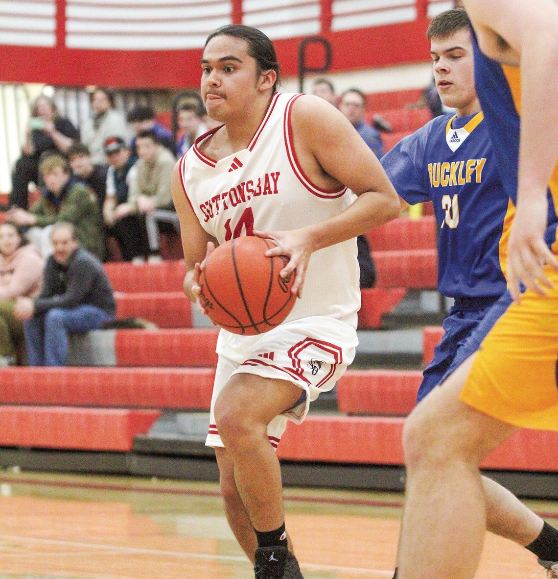 Suttons Bay junior Darius Lopez drives the lane before finding a teammate during a Northwest Conference boys basketball game on Monday against Buckley. Enterprise photo by Brian Freiberger