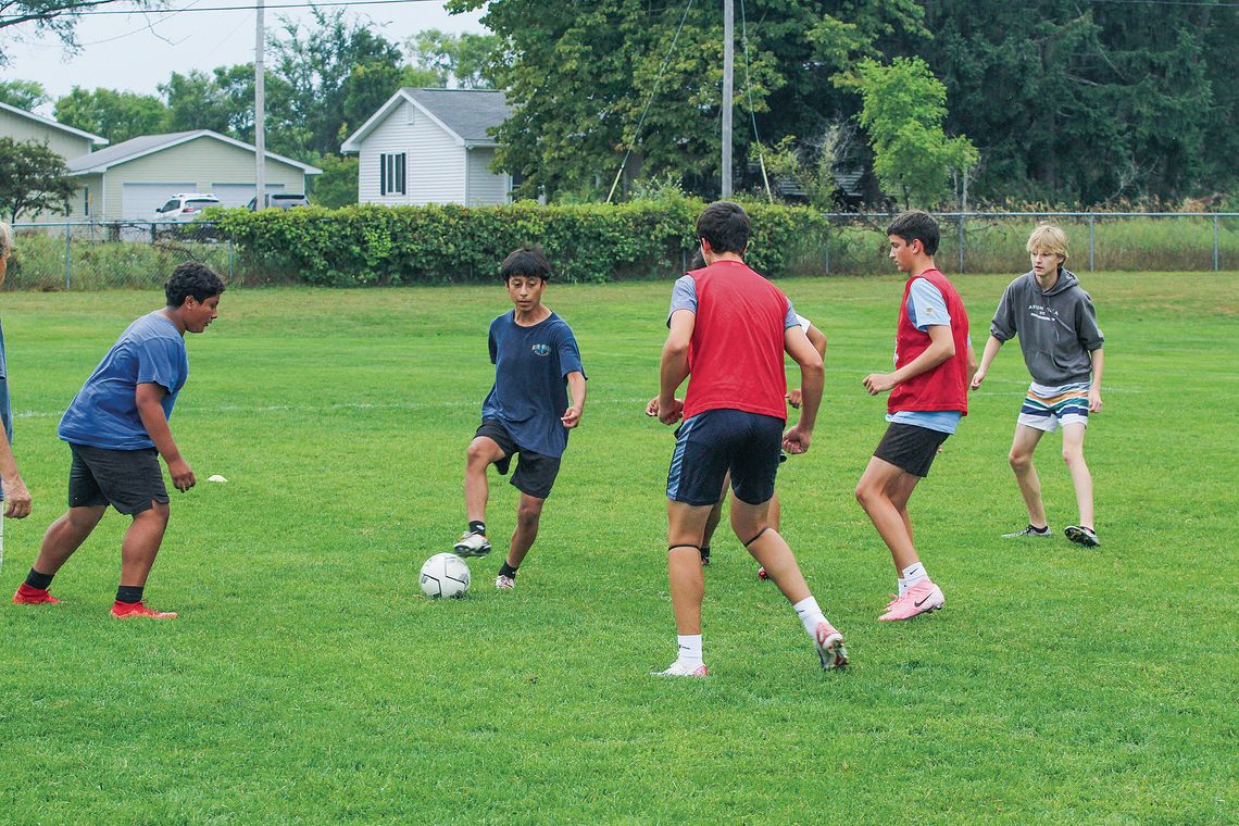 Suttons Bay sophomore Julian Garcia dribbles between teammates during a drill at practice last week. Enterprise photo by Brian Freiberger