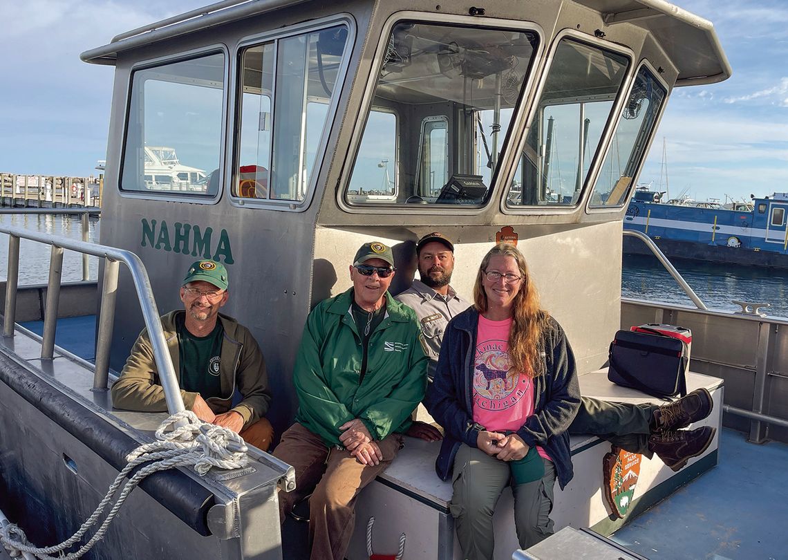 Sleeping Bear Dunes National Lakeshore Sleeping Bear Dunes National Lakeshore volunteers (from left to right) John England, Patty Kelly, boat captain Adam Reitz, and Mandy England are pictured Wednesday morning while loading up for a two week trip to South Manitou Island. Kelly, 72, has been volunteering with the National Park...