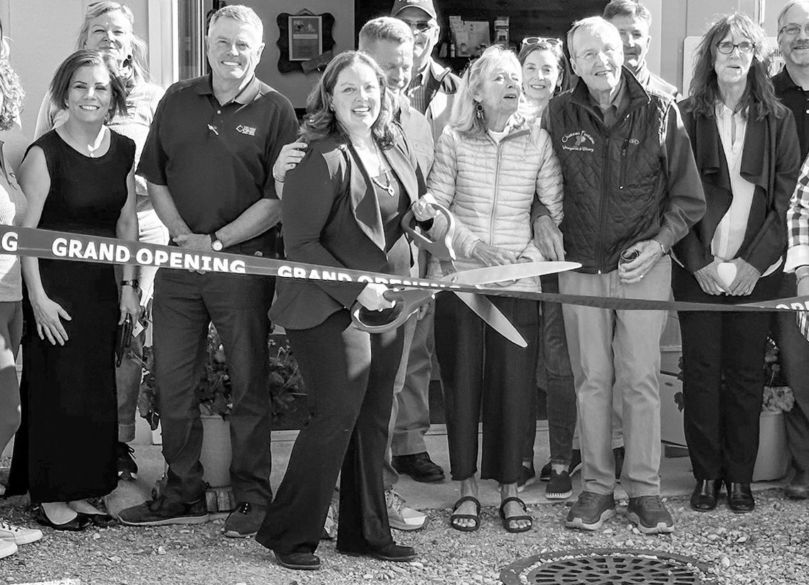 Dr. Carrie Sands of Leland (middle) cut the ribbon to her new sports chiropractic office in Leland in May. Courtesy photo