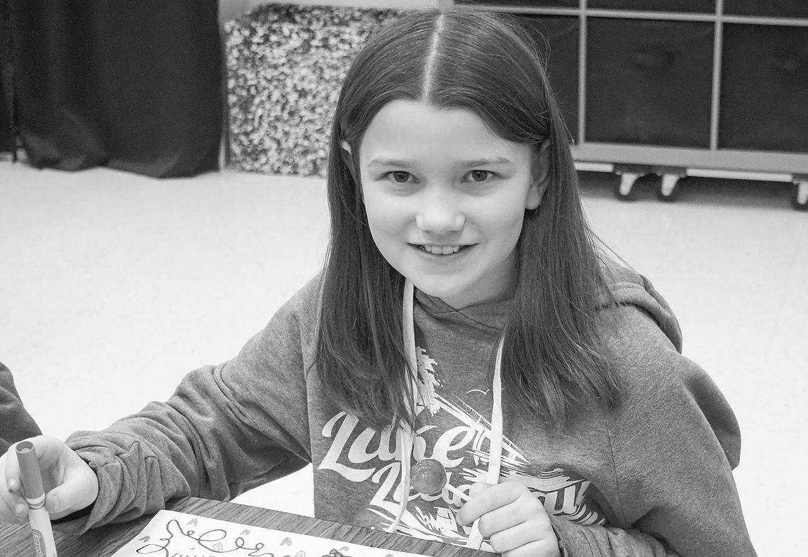 In celebration of community, Lilyana Graham, grade 5, decorates placemats for the spaghetti dinners to support Leelanau Christian Neighbors. Courtesy photos