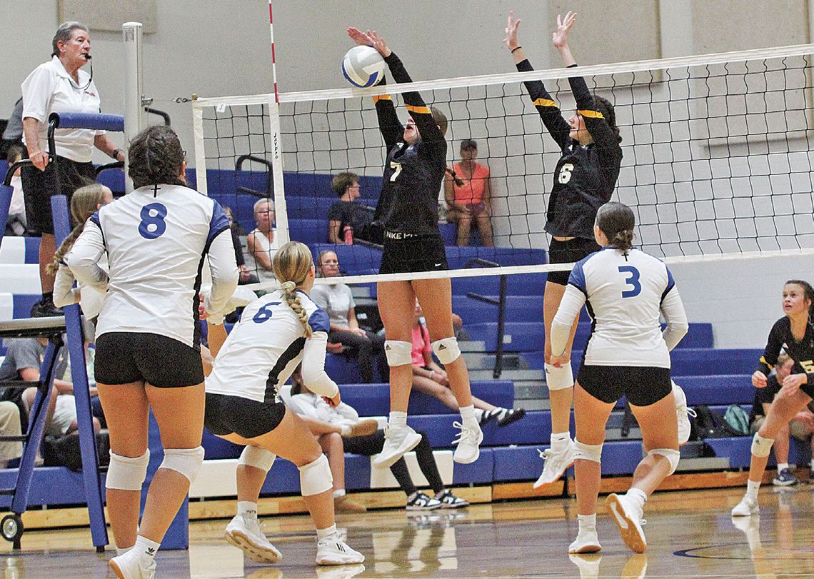 Glen Lake defender Lydia Brammer blocks a Lake Leelanau St. Mary kill from senior Cathryn Mikowski during a four set win for the Eagles last week. Enterprise photo by Brian Freiberger