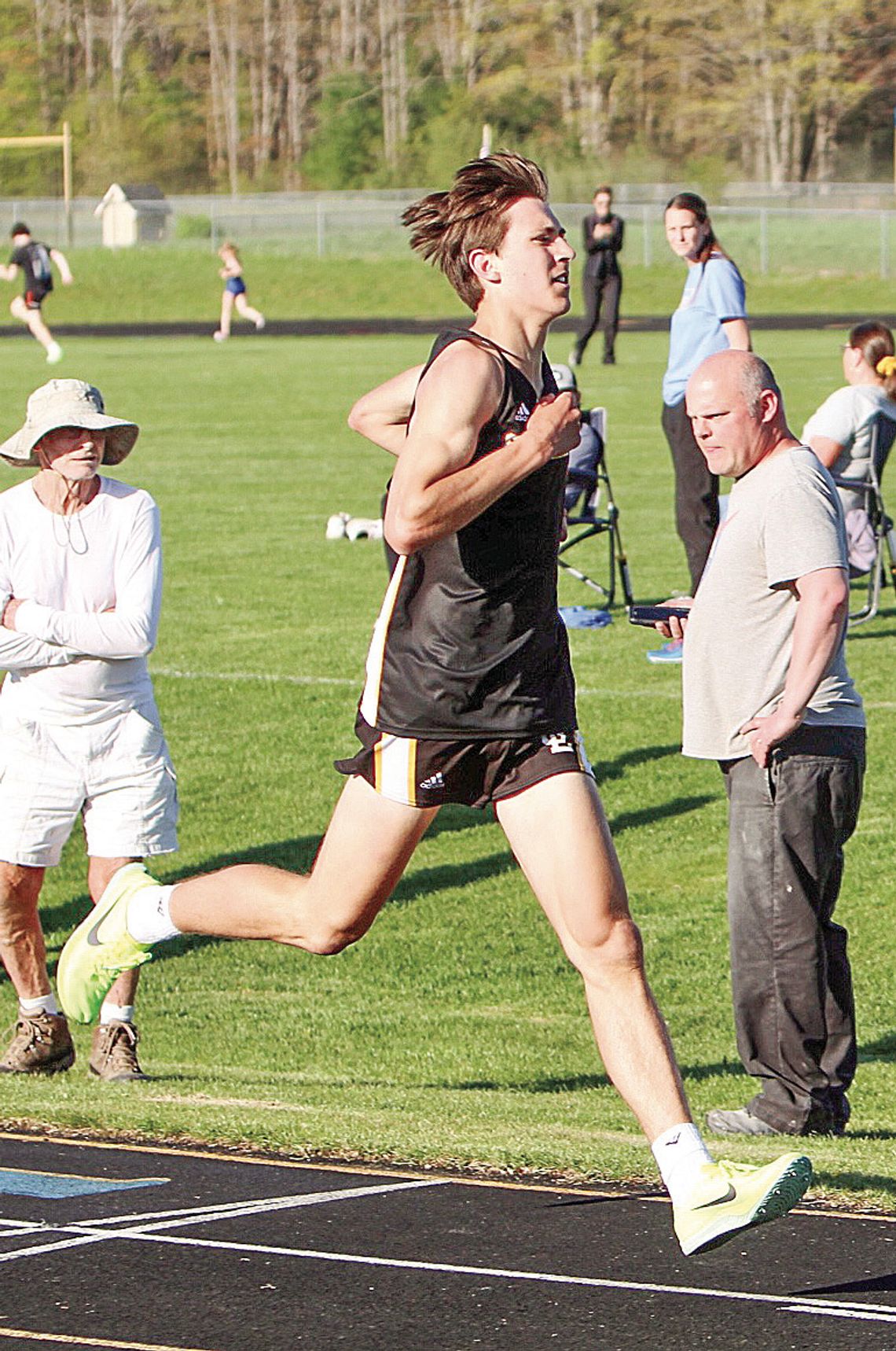 Glen Lake junior Colebrook Sutherland broke the school record for the two-mile on Monday with a time of 9:50.9. He beat the record set by Justin Kibbey in 1999 by nine seconds. Sutherland crosses the finish line as Laker long distance coach Jim Harrelsson (right) hits his timer. Photo cour...