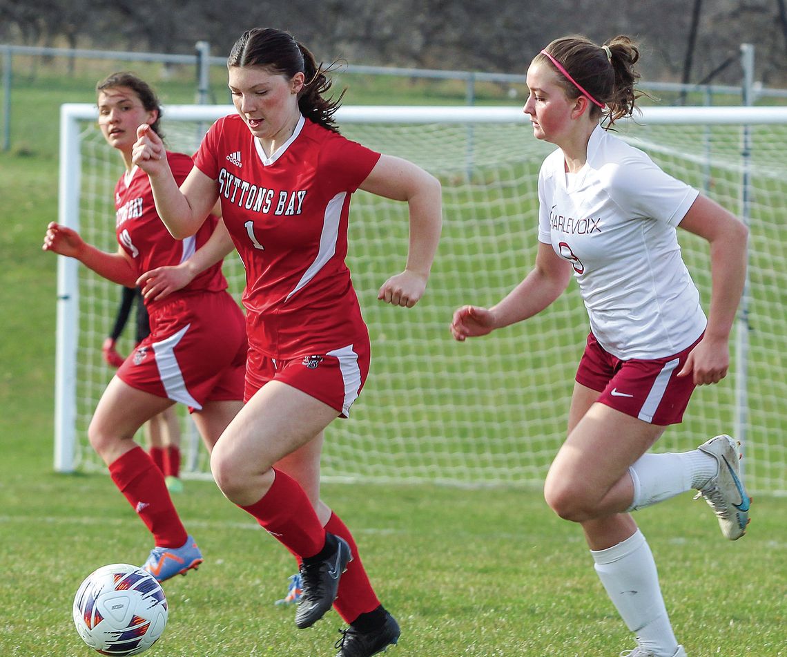 Suttons Bay sophomore defender Clarice Bardenhagen dribbles past a Charlevoix defender on Monday. Enterprise photo by Brian Freiberger