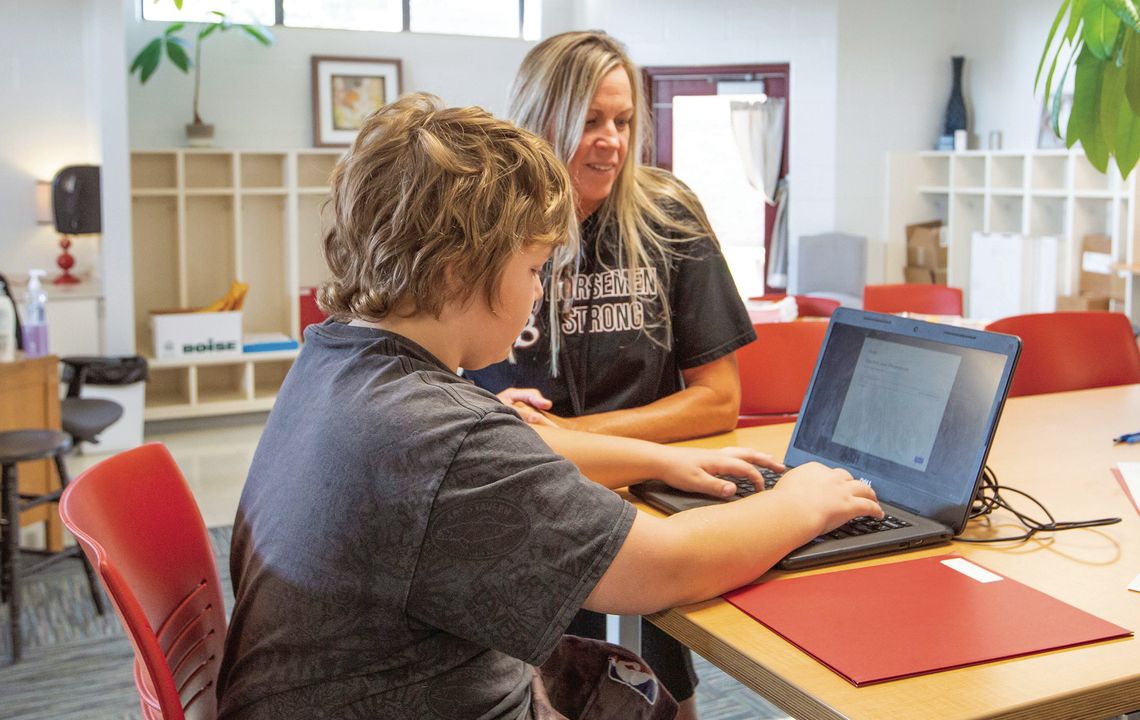 Teacher Michelle Couturier helps a student with an assignment. Courtesy photo