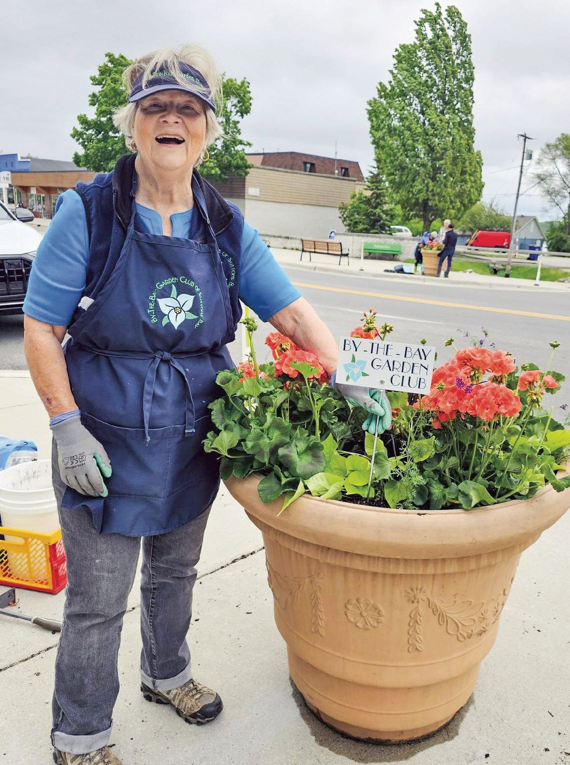 The By the Bay Garden Club The By the Bay Garden Club planted over 20 flower pots for downtown Suttons Bay this morning. They will be placed around town in time for Memorial Day weekend and will remain in town until the fall. Pictured above is member Pat Ard. Courtesy photo