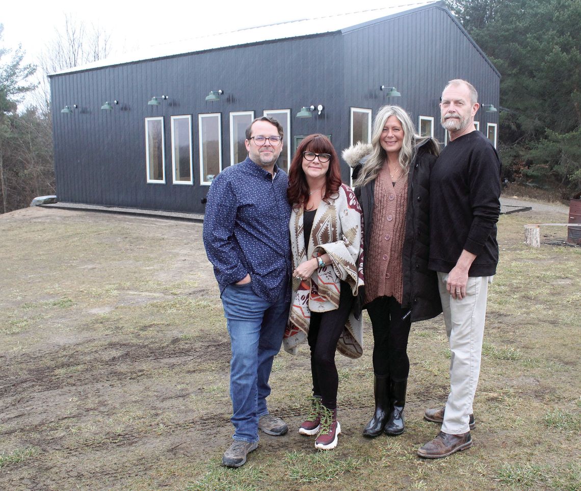 Three Trees Vineyard in Suttons Bay announced it will be aiming to open by summertime 2024. Phil and Lyle Cifuentes (left), and Scott and Laurie Muschong celebrate in the rain earlier this week. Enterprise photo by Brian Freiberger