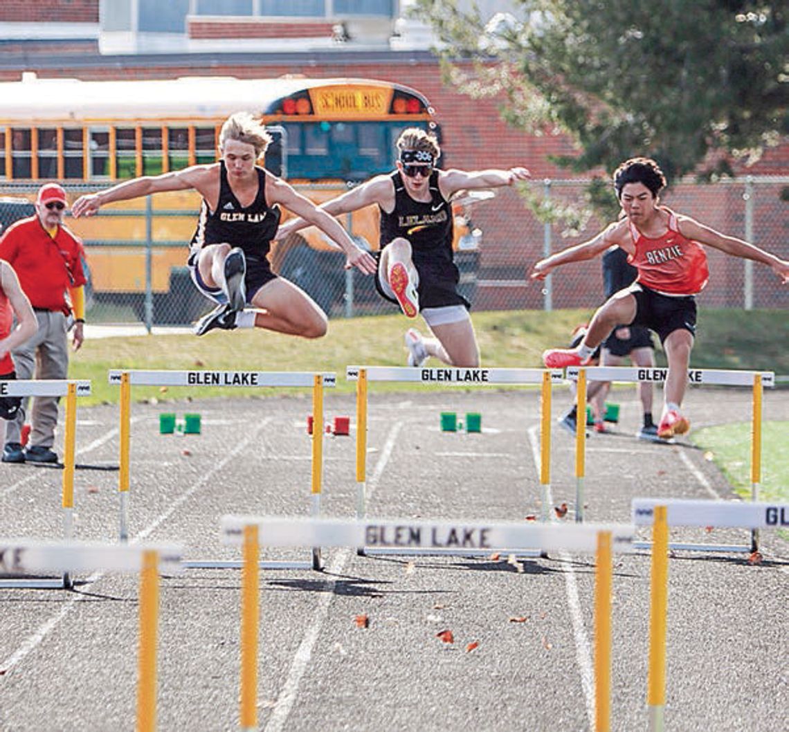 Glen Lake, Leland, and Benzie Central 300-meter hurdlers compete during the first track meet of the season. From left to right Caden Sheehan, Jimmy Alpi and Joseph Abeyta. Photo courtesy of Bob Alpi
