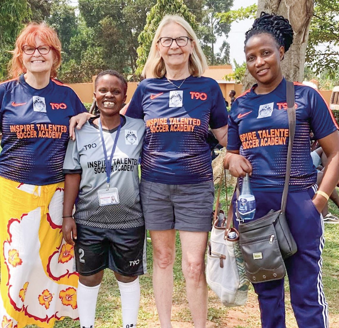 Courtesy photo Mary Taylor (left) and Judy Yoder (right) stand with women soccer players in Uganda a few year ago. A nonprofi t soccer program created by Leland seventh graders in 2016 has grown from 20 to 500, but recent developments have resulted in a fundraising effort to purchase the s...